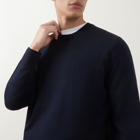 Model wearing Boss Black Casual Leno Knitted Sweater in dark blue, crew neck with ribbed trims, styled over a white crew neck top.