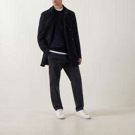 Model wearing Boss Black Casual Leno Dark Blue crew neck wool knit sweater, styled with navy overcoat, charcoal trousers and white trainers.