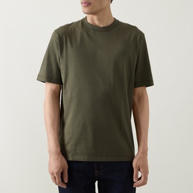 Model wearing Boss Black Casual H-Taut Logo T-Shirt in Open Green, crew neck, dropped shoulders, short sleeves, styled with dark jeans
