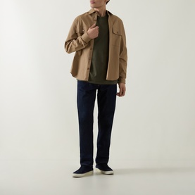Model wearing Boss Black Casual H-Taut Logo T-Shirt in Open Green, styled with a tan overshirt and navy jeans.