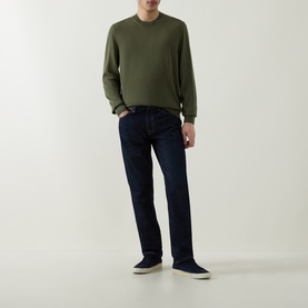 Model wearing Boss Black Casual Leno Knitted Sweater in Open Green, styled with dark indigo jeans and navy canvas trainers.