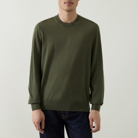 Model wearing Boss Black Casual Leno Knitted Sweater in Open Green, crew neck, fine-knit wool, ribbed trims, styled with dark jeans