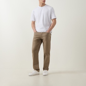 Model wearing Boss Black Casual H Taut Logo T-Shirt in Open White with khaki straight-leg trousers and white trainers