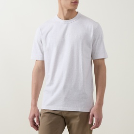 Model wearing Boss Black Casual H Taut Logo T-Shirt in Open White, crew neck, short sleeves, styled with khaki trousers