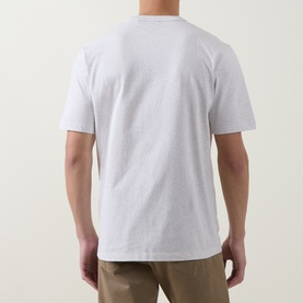 Model wearing Boss Black Casual H Taut Logo T-Shirt in Open White, rear view, crew neck, short sleeves, styled with khaki trousers
