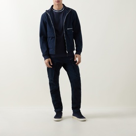 Model wearing Boss Black Casual Thompson Tipped T-Shirt in dark blue, styled with navy zip-up hoodie, dark jeans and navy suede shoes.