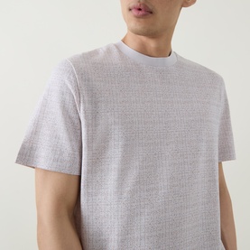 Model wearing Boss Black Casual Thompson Textured Logo T-Shirt in Open White, crew neck with subtle textured pattern and short sleeves