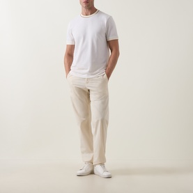 Model wearing Boss Black Casual Thompson Tipped T-Shirt in Open White with tipped neckline trim, styled with cream trousers and white trainers.