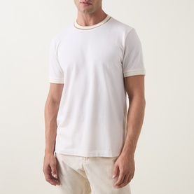 Model wearing Boss Black Casual Thompson Tipped T-Shirt in Open White with contrast tipped trims at neck and cuffs, styled with cream trousers