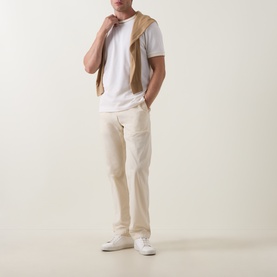Model wearing Boss Black Casual Thompson Tipped T-Shirt in Open White, styled with cream cargo trousers, tan knit vest and white trainers.