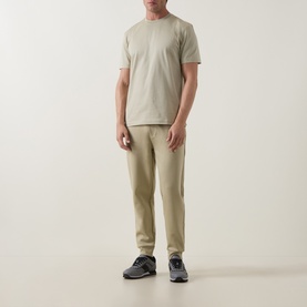 Model wearing Boss Black Casual Thompson Logo T-Shirt in dark beige with matching beige trousers and grey trainers.