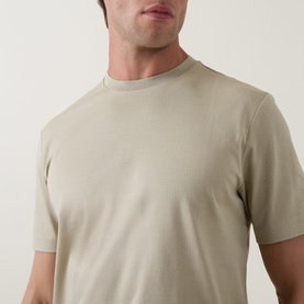 Model wearing Boss Black Casual Thompson Logo T-Shirt in dark beige, crew neck, short sleeves, textured cotton finish