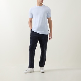 Model wearing Boss Black Casual Thompson Tipped T-Shirt in Open Blue with navy trousers and white trainers