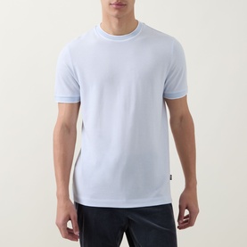 Model wearing Boss Black Casual Thompson Tipped T-Shirt in Open Blue, crew neck with tipped trims, short sleeves, paired with dark trousers