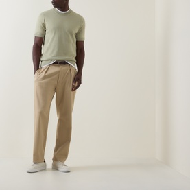 Model wearing Boss Black Casual Umauro Knitted Sweater in Dark Beige, crew neck, short sleeves, styled with tan trousers and white trainers.