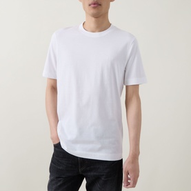 Model wearing Boss Black Casual white crew neck T-shirt in 100% cotton, paired with dark jeans.