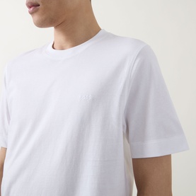 Model wearing Boss Black Casual white crew neck T-shirt in 100% cotton, shown in close-up torso shot with subtle logo detail.