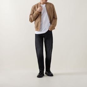 Model wearing Boss Black Casual white crew neck T-shirt, styled with camel zip jacket, dark wash jeans and black chunky sole shoes.