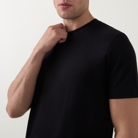 Model wearing Boss Black Casual black crew neck T-shirt in cotton, close-up showing tonal chest logo detail