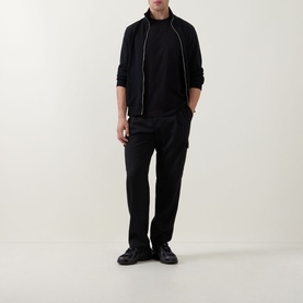 Model wearing Boss Black Casual black crew neck T-shirt, styled with black zip-through jacket, black trousers and black shoes.