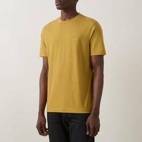 Model wearing Boss Black Casual gold crew neck cotton T-shirt with small chest logo, styled with dark jeans