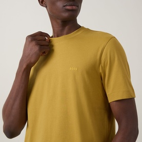 Model wearing Boss Black Casual gold crew neck T-shirt in 100% cotton, with small logo embroidery at chest