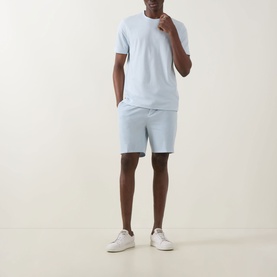 Model wearing Boss Black Casual Open Blue cotton crew neck T-shirt, styled with matching light blue shorts and white trainers.