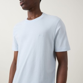 Model wearing Boss Black Casual Open Blue crew neck T-shirt in 100% cotton, close-up showing chest logo detail