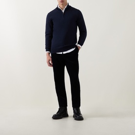 Model wearing Boss Black Casual Benji Half-Zip Sweater in dark blue wool, styled with white shirt and black trousers and shoes.