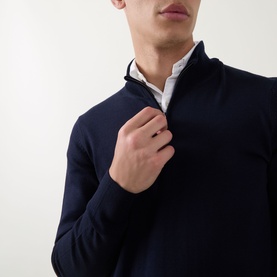 Model wearing Boss Black Casual Benji Half-Zip Sweater in dark blue, styled over a white shirt, with half-zip fastening and high neckline visible.