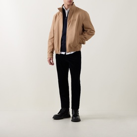 Model wearing Boss Black Casual Benji Dark Blue Half-Zip Sweater, styled with a camel bomber jacket, white shirt, and black trousers.