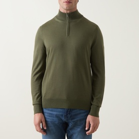 Model wearing Boss Black Casual Ebenji Half-Zip Sweater in Open Green, styled with blue jeans. Funnel neck, ribbed trims, virgin wool knit.