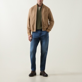 Model wearing Boss Black Casual Ebenji Half-Zip Sweater in Open Green, styled with camel bomber jacket and blue jeans