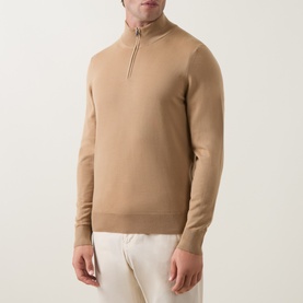Model wearing Boss Black Casual Benji Half-Zip Sweater in medium beige wool, with ribbed trims and silver zip detail, styled with white trousers.