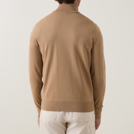 Model wearing Boss Black Casual Benji Half-Zip Sweater in medium beige, rear view, showing ribbed trims and straight hem. Styled with white trousers.