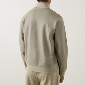 Model wearing Boss Black Casual Sidney Half-Zip Sweatshirt in dark beige, shown from behind, with matching beige trousers.