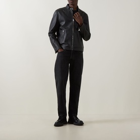 Model wearing Boss Black Casual black lamb leather jacket with zip fastening, styled with black trousers and black loafers.