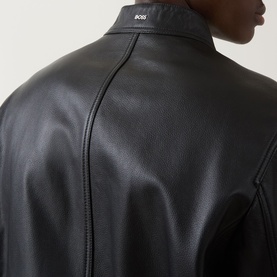 Model wearing Boss Black Casual black lamb leather jacket, close-up of rear collar and central back seam detail.