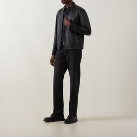Model wearing Boss Black Casual black lambskin leather jacket, styled with dark tailored trousers and black shoes.
