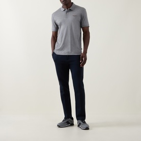 Model wearing Boss Black Casual Parlay Logo Polo Shirt in Open Grey with navy trousers and grey trainers.