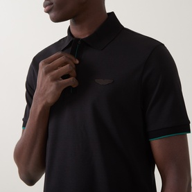 Model wearing Boss Black Casual black cotton polo shirt with tipped green and teal cuffs and tonal chest logo, zip placket detail