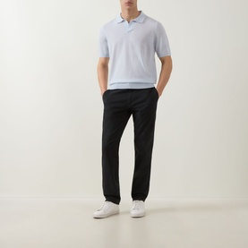 Model wearing Boss Black Casual H Lantoni Logo Polo Sweater in Open Blue fine-knit wool, styled with black tapered trousers and white trainers.