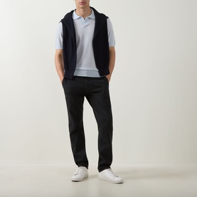 Model wearing Boss Black Casual H Lantoni Logo Polo Sweater in Open Blue, styled with a black gilet, black trousers and white trainers.