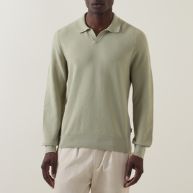 Model wearing Boss Black Casual H Lomarino Logo Polo Sweater in dark beige, long sleeves, open polo collar, ribbed trims, styled with cream trousers