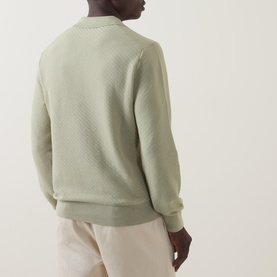 Model wearing Boss Black Casual H Lomarino Logo Polo Sweater in Dark Beige, back view, ribbed trims, textured-knit, styled with cream trousers