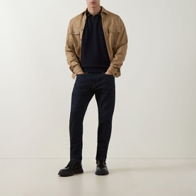 Model wearing Boss Black Casual H Lomarino Logo Polo Sweater in dark blue, styled with tan overshirt, dark jeans and black boots