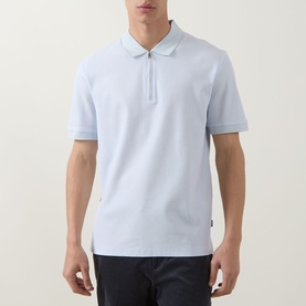 Model wearing Boss Black Casual H Pei Logo Zip Polo Shirt in Open Blue, half-zip placket, textured cotton, paired with dark trousers