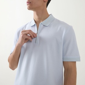 Model wearing Boss Black Casual H Pei Logo Zip Polo Shirt in Open Blue, showing half-zip placket, polo collar and short sleeves