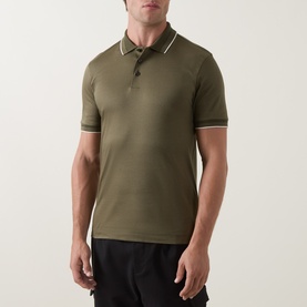Model wearing Boss Black Casual Open Green cotton polo shirt with contrast white tipped collar and cuffs, styled with black trousers