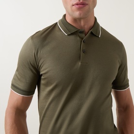 Model wearing Boss Black Casual Open Green cotton polo shirt with white tipped collar and cuffs, three-button placket, short sleeves